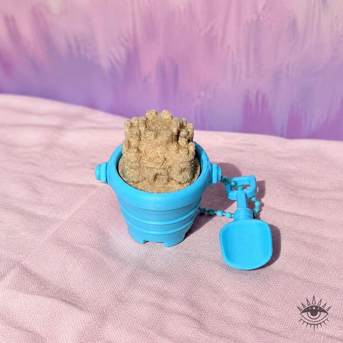Sand Castle Clicker on pink linen